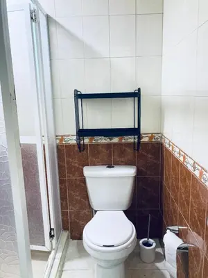 a bathroom with a white toilet and a mirror at Auténtico apartamento en centro histórico con arte in Cartagena de Indias