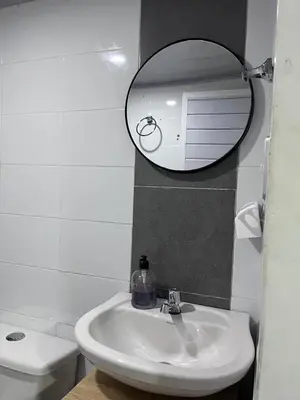 a bathroom with a sink and a mirror and a toilet at CasaMartina in Cartagena de Indias
