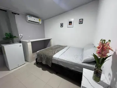 a bedroom with a bed and a table with flowers at CasaMartina in Cartagena de Indias