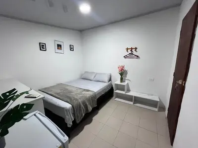 a small bedroom with a bed and a table at CasaMartina in Cartagena de Indias