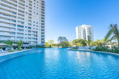 a large swimming pool in front of two tall buildings at Apartamentos Exclusivos Santa Marina - AR Rentals in Santa Marta