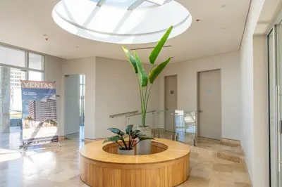 a lobby with a round table with a plant in it at Apartamentos Exclusivos Santa Marina - AR Rentals in Santa Marta