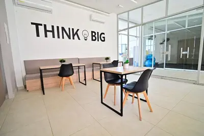 a restaurant with tables and chairs and a sign that reads think and big at Apartamento en Cartagena elegante con piscina in Manzanillo del Mar