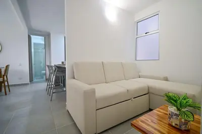 a living room with a white couch and a table at Apartamento en Cartagena elegante con piscina in Manzanillo del Mar