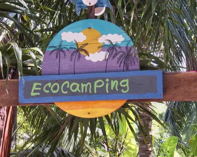 a sign that says ocean ring hanging from a tree at Coco Encantado Eco Hostal Camping in Cartagena de Indias