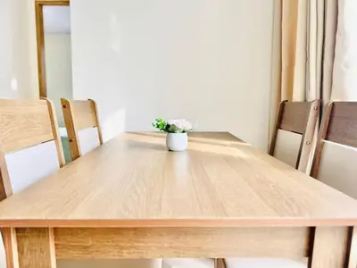 a wooden table with a vase of flowers on it at Sagitario apartment at 5 minutes from the beach and old city in Cartagena de Indias