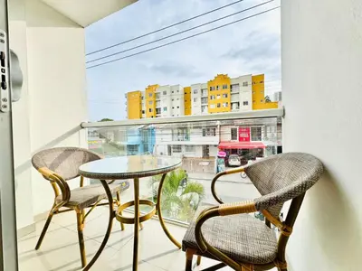 a balcony with a table and chairs and a window at Sagitario apartment at 5 minutes from the beach and old city in Cartagena de Indias