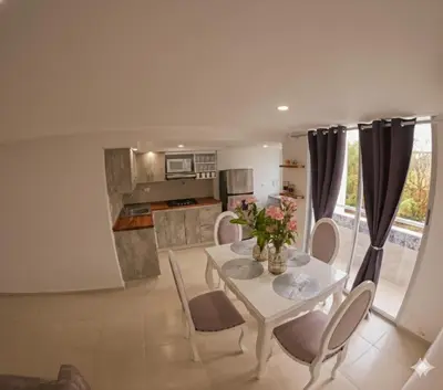 a kitchen and dining room with a white table and chairs at Fenix, Apartamento En Coveñas, Primer piso, 103 in Coveñas
