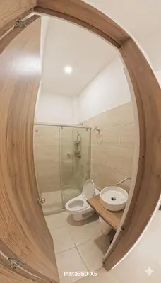 a bathroom with two toilets and a glass shower at Fenix, Apartamento En Coveñas, Primer piso, 103 in Coveñas