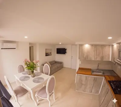 a kitchen and living room with a table and chairs at Fenix, Apartamento En Coveñas, Primer piso, 103 in Coveñas