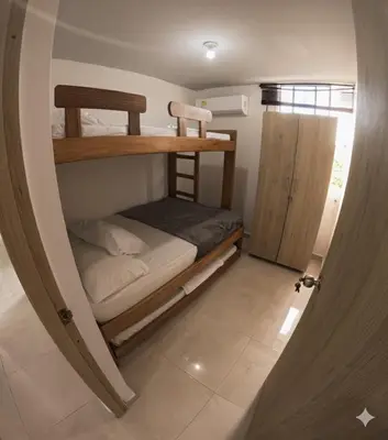 a room with two bunk beds and a door at Apartamento Caribeño 1203 in Coveñas