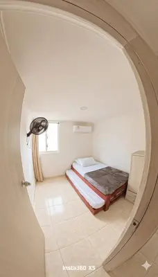 a small room with a bed and a window at Apartamento Caribeño 1203 in Coveñas