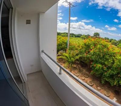 a balcony with a view of a field of flowers at Apartamento Caribeño 1203 in Coveñas