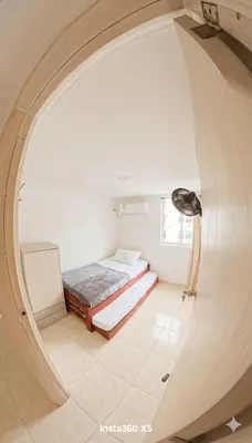 a small room with a bed and a window at Apartamento Caribeño 1203 in Coveñas