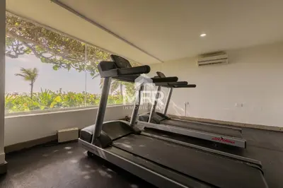 a gym with a treadmill and a large window at Morros 3, Beachfront & 2 Bedrooms in Cartagena de Indias