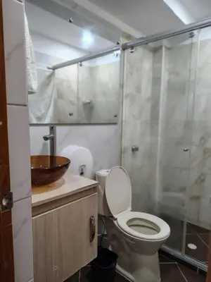 a bathroom with a toilet and a glass shower at Teca, Apto , Caribe in Coveñas