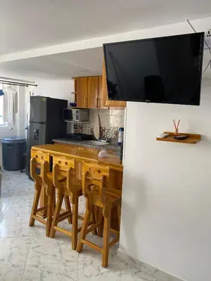 a kitchen with a large television on a wall at Teca, Apto , Caribe in Coveñas