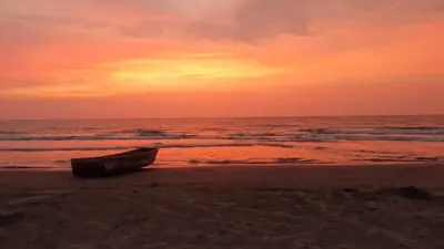 a boat sitting on the beach at sunset at NOK Oceanside getaway in Cartagena in Cartagena de Indias