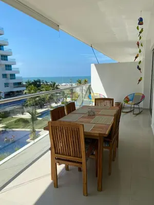 a dining room with a table and chairs and a large window at NOK Oceanside getaway in Cartagena in Cartagena de Indias