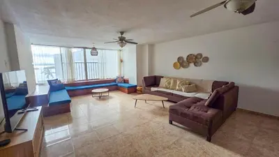 a living room with a couch and a ceiling fan at Apt 3 rooms Laguito Cartagena 1 block from the beach in Cartagena de Indias