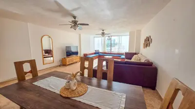 a living room with a table and a couch at Apt 3 rooms Laguito Cartagena 1 block from the beach in Cartagena de Indias