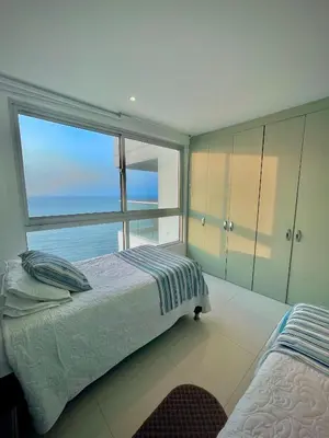 a bedroom with a bed and a large window at Apartamento de 2 Habitaciones Vista al Mar in Cartagena de Indias