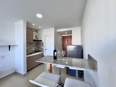 a kitchen with a counter with two glasses of wine at Apto 894 in Cartagena de Indias