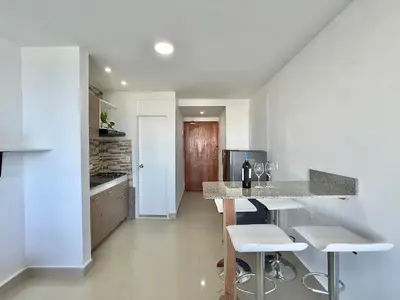 a kitchen with a bar with stools and a counter at Apto 894 in Cartagena de Indias