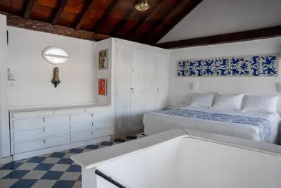 a bedroom with a bed and a checkered floor at Boutique Colonial en el Centro Histórico in Cartagena de Indias