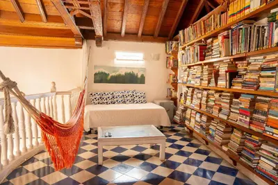 a room with a hammock and bookshelves at Boutique Colonial en el Centro Histórico in Cartagena de Indias