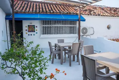 a patio with a table and chairs and a building at Boutique Colonial en el Centro Histórico in Cartagena de Indias