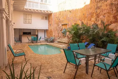 a patio with a table and chairs and a pool at Boutique Colonial en el Centro Histórico in Cartagena de Indias