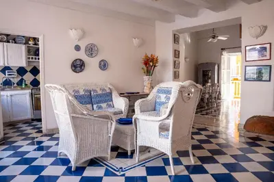 a living room with wicker chairs and a table at Boutique Colonial en el Centro Histórico in Cartagena de Indias