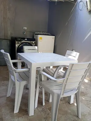 a white table and chairs in a room with a stove at Posada mary in Cartagena de Indias