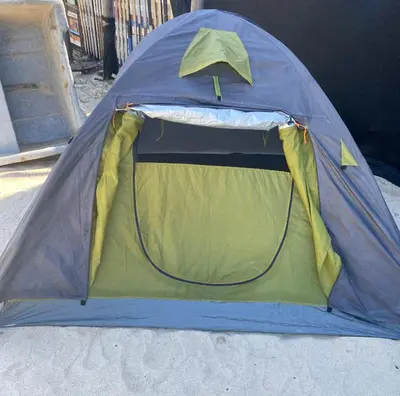 a blue and green tent sitting in the sand at Amora Beach Camping in Baru