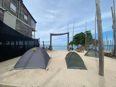 two tents sitting in the sand near the ocean at Amora Beach Camping in Baru