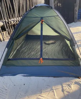 a tent sitting on the sand on the beach at Amora Beach Camping in Baru