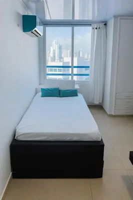 a bed in a room with a large window at Azul Caribe Home in Cartagena de Indias