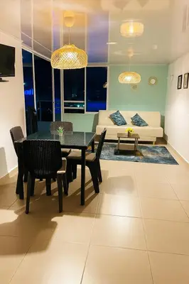 a living room with a dining table and a couch at Azul Caribe Home in Cartagena de Indias