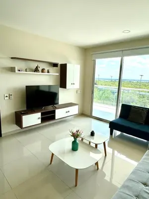 a living room with a tv and a couch and a table at Apartamento con piscina gigante y acceso directo al mar in Cartagena de Indias