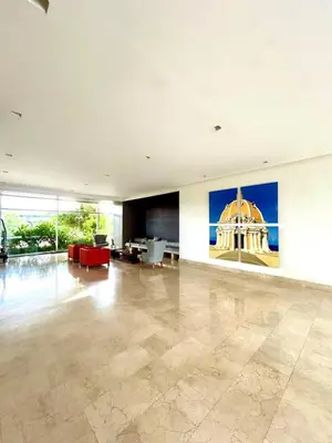 a large living room with a large painting on the wall at Apartamento con piscina gigante y acceso directo al mar in Cartagena de Indias