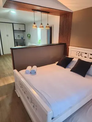 a bedroom with a large bed with two slippers on it at Lagoon & see view studio Cartagena in Cartagena de Indias