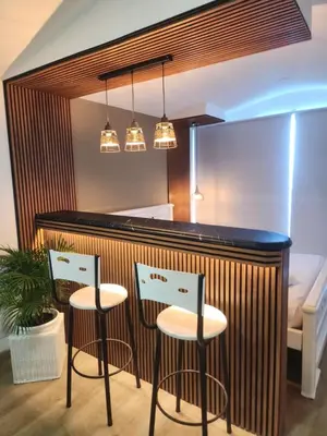 a bar with two stools in front of a counter at Lagoon & see view studio Cartagena in Cartagena de Indias