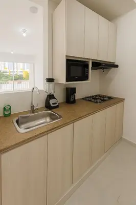 a kitchen with a sink and a microwave at Cartagena Apartamento completo vista al mar in Cartagena de Indias