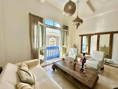 a living room with a white couch and a table at By Calamari Homes - Ayos 206 - Walled City in Cartagena de Indias