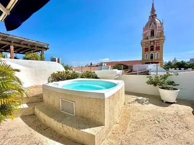 a hot tub sitting on top of a building with a clock tower at By Calamari Homes - Ayos 206 - Walled City in Cartagena de Indias