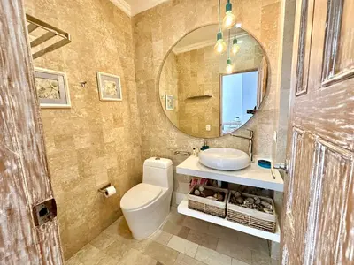a bathroom with a sink and a toilet and a mirror at By Calamari Homes - Ayos 206 - Walled City in Cartagena de Indias