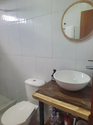 a bathroom with a sink and a toilet and a mirror at Hostal Casa Adela