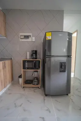 a kitchen with a stainless steel refrigerator and a microwave at Aqualina 209 y 512 in Cartagena de Indias