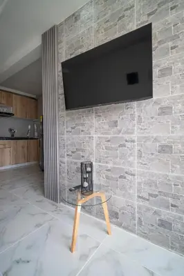 a tv hanging on a brick wall with a table at Aqualina 209 y 512 in Cartagena de Indias